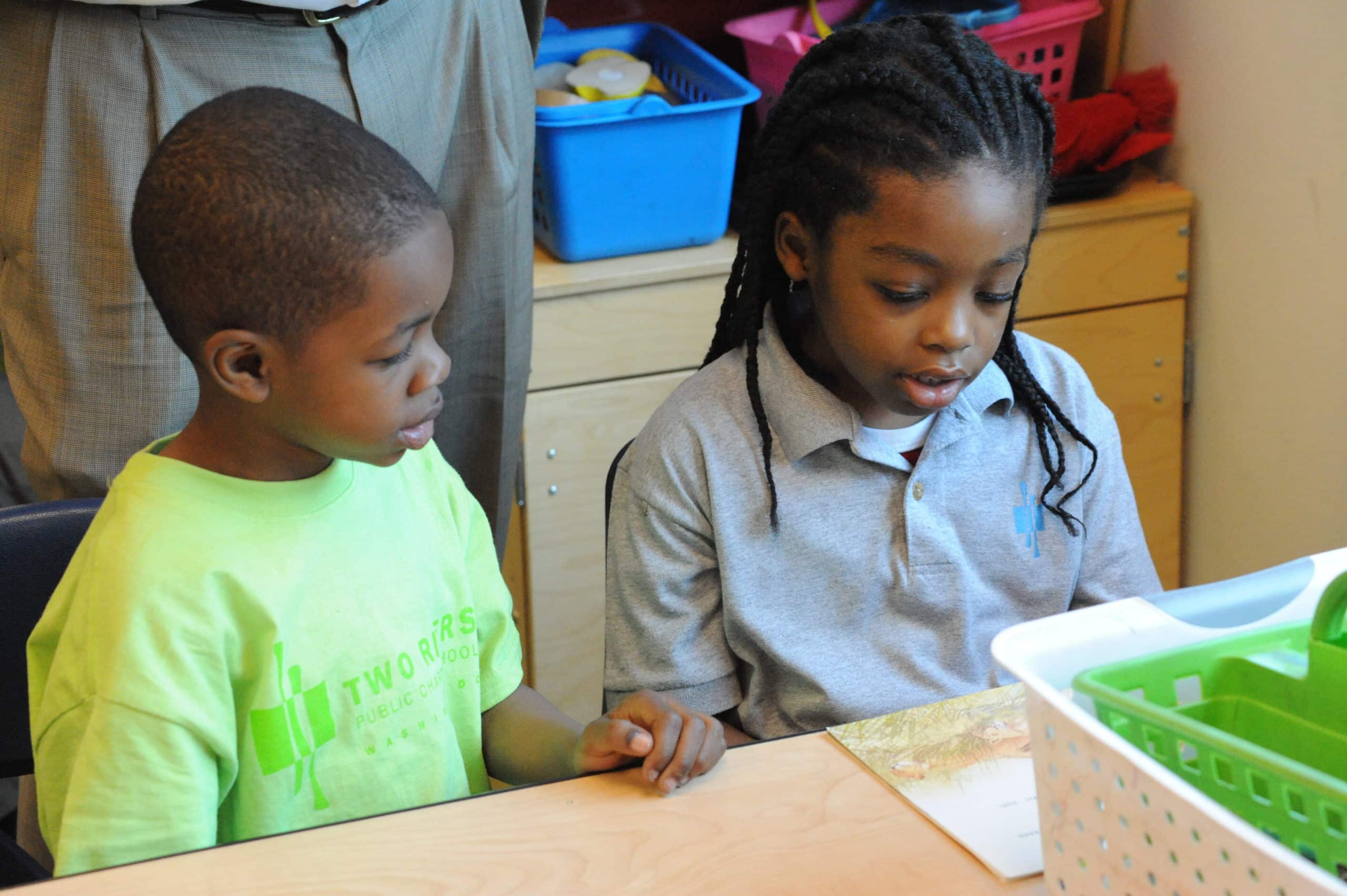 Two students look at project together