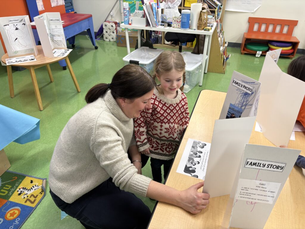 Preschool students showing her mom her family story.